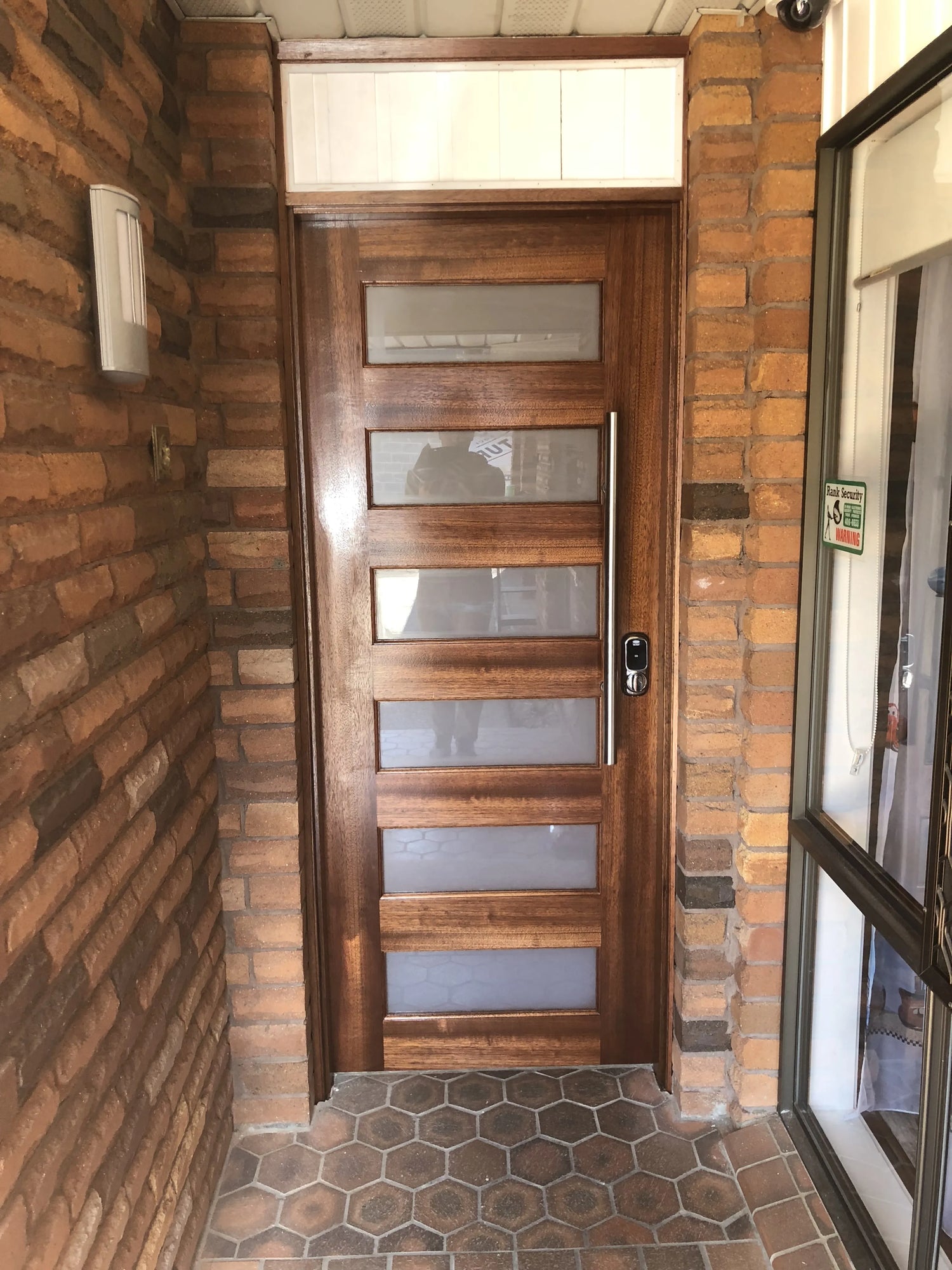 6H external door stained in merbau colour and installed with electronic lock and round pull handle