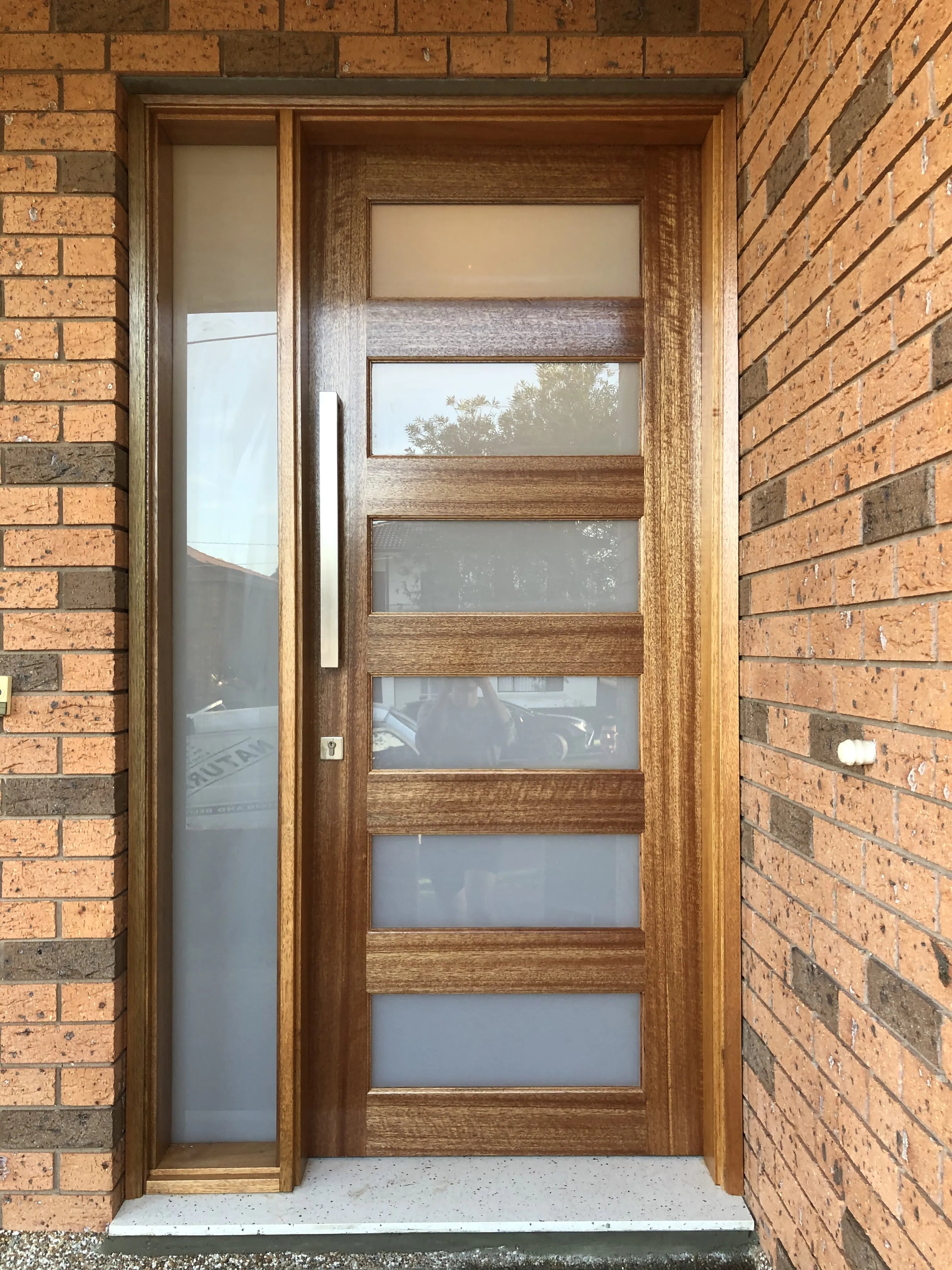 Stained 2340 Front door installed with fixed glass side panel.