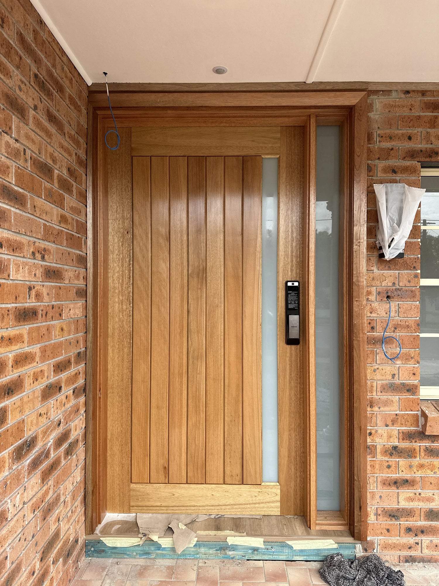 Timber joinery door 2340x1200x40mm with fixed glass side panel, installed in Greenacre with electronic lock