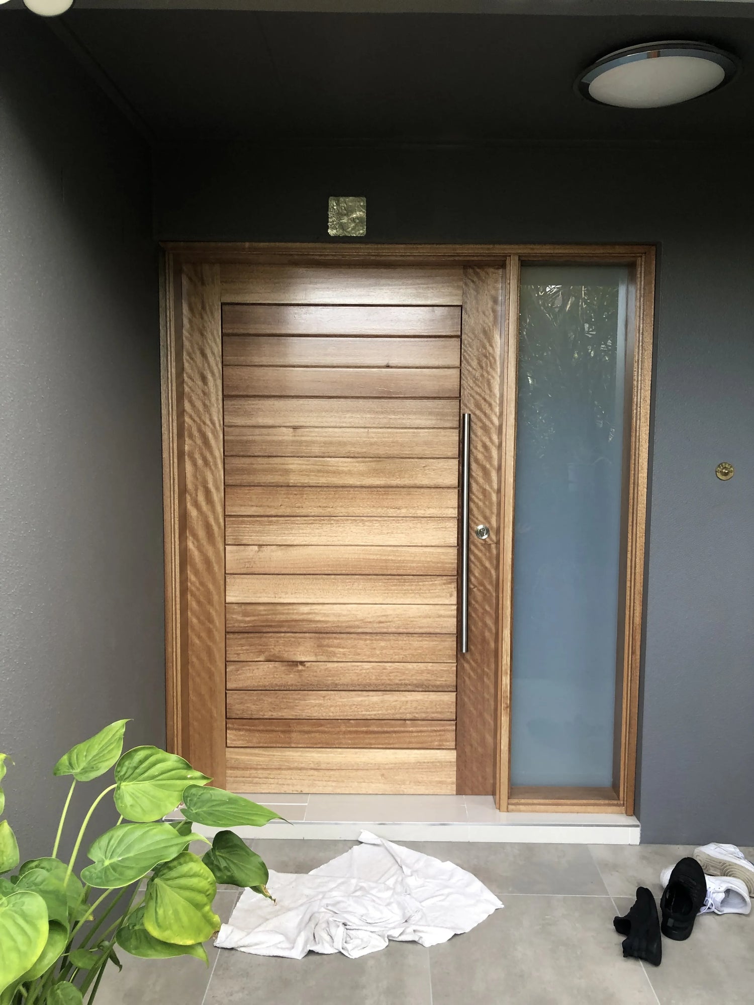 Joinery Front Door installed with fixed side panel of translucent laminate glass.