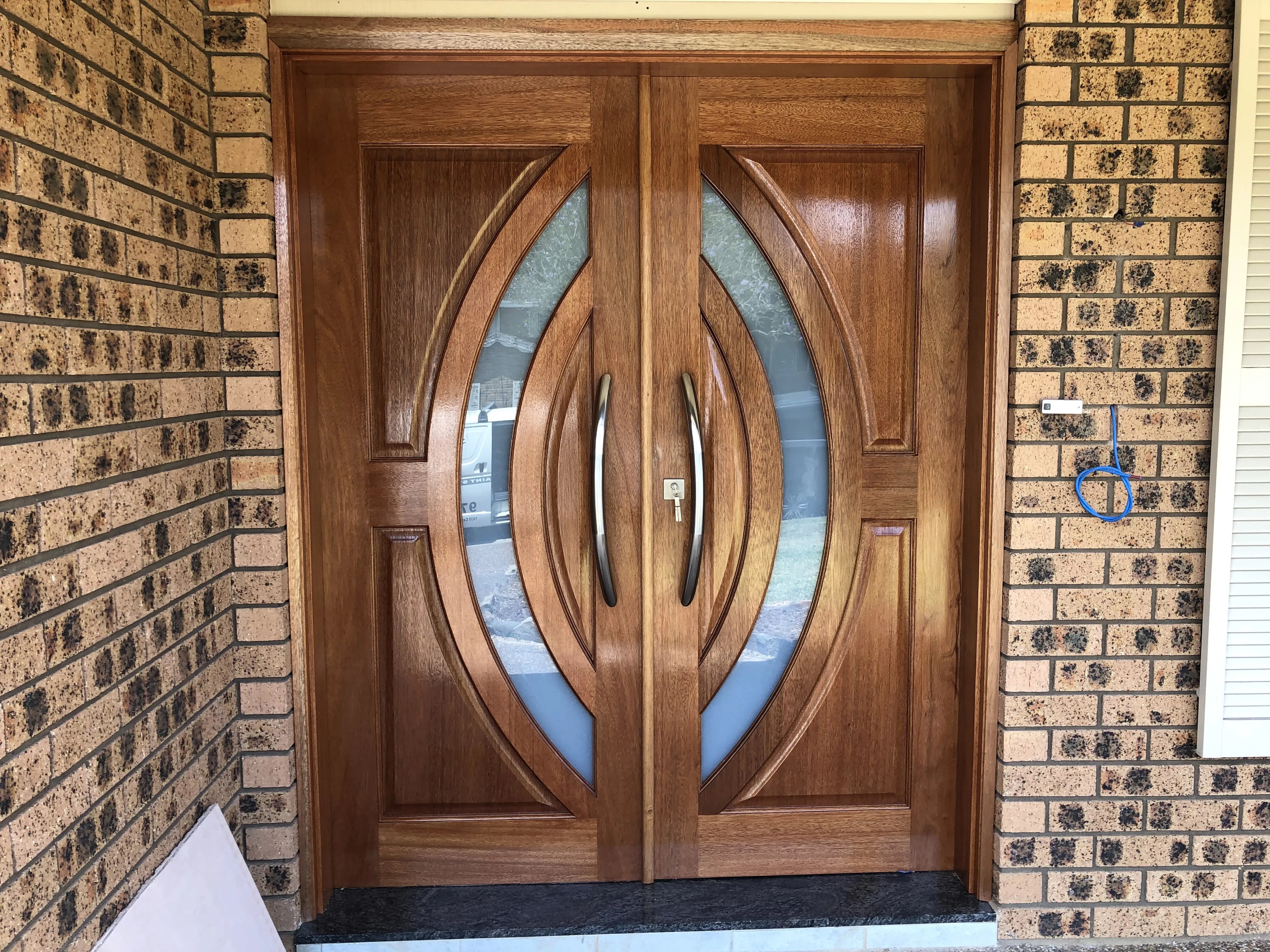 Stained Solid Timber Doors with curved frosted glass and matching curved pull handles