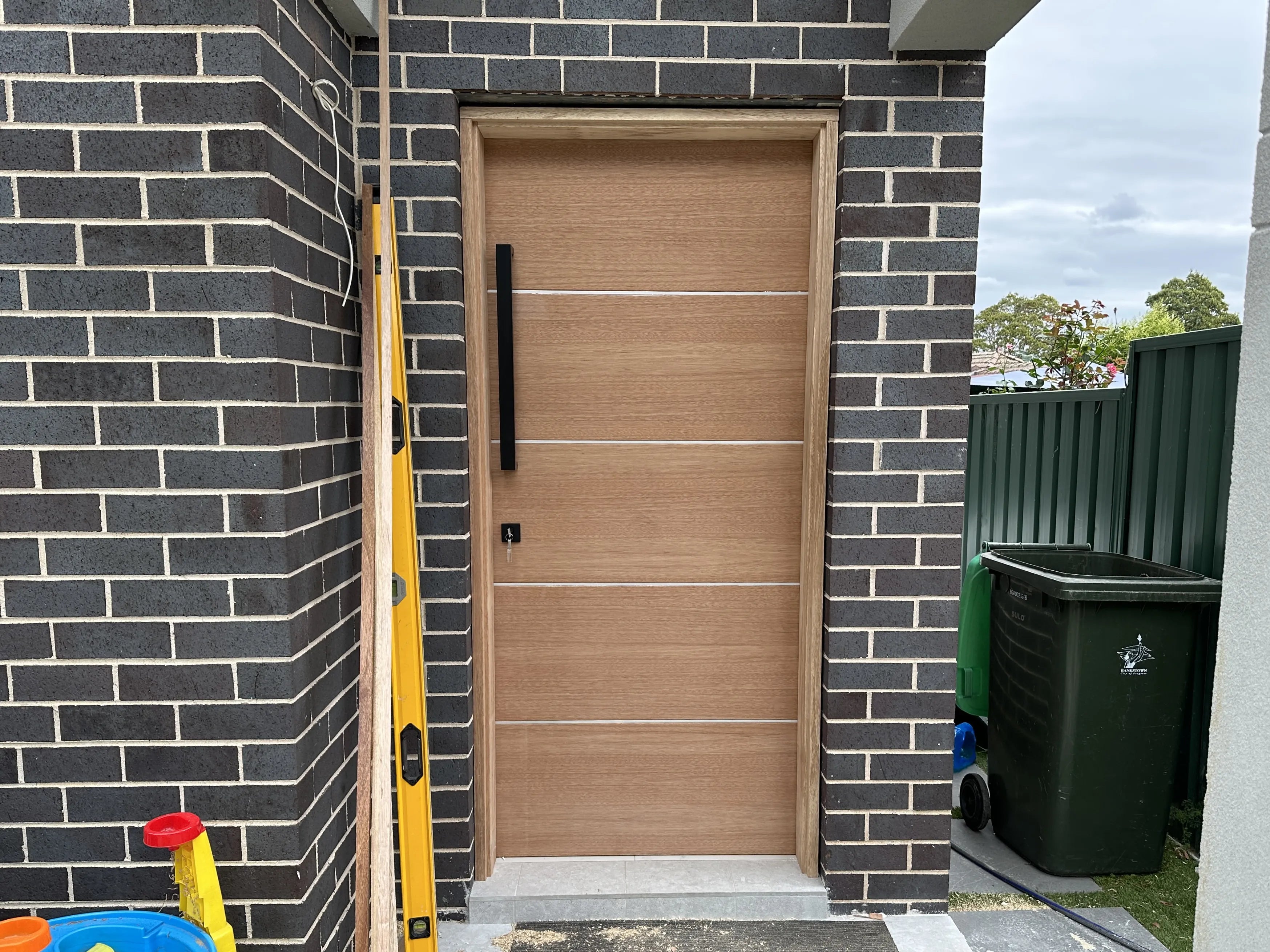 External door installed in Granny Flat in Bankstown with black pull handle and mortice lock