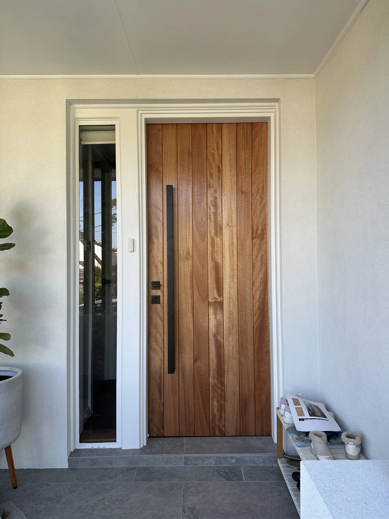 Entrance Door with clear varnish finish and black door lock and long pull handle installed in Sydney